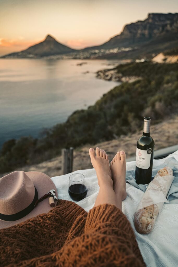 pexels-photo-7608000-7608000 Tranquil picnic at sunset with wine and ocean view. Perfect for relaxation.